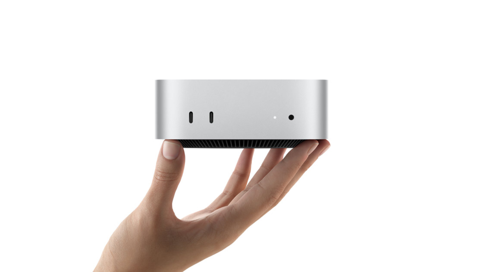 Apple 官方 Mac mini 產品圖，顯示新款桌機的正面連接埠與小型機身